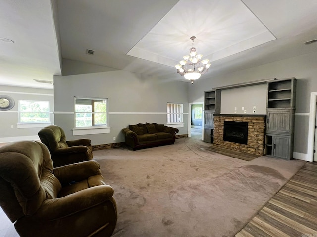 5942 Joey Ln, Texarkana, AR 71854 - carpeted living room featuring a chandelier, a fireplace, and a raised ceiling