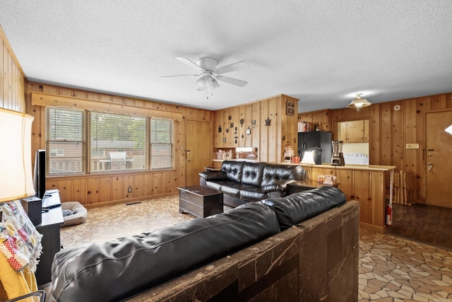 1903 W Arch Ave, Searcy, AR 72143 - living area featuring wood walls, ceiling fan, and a textured ceiling