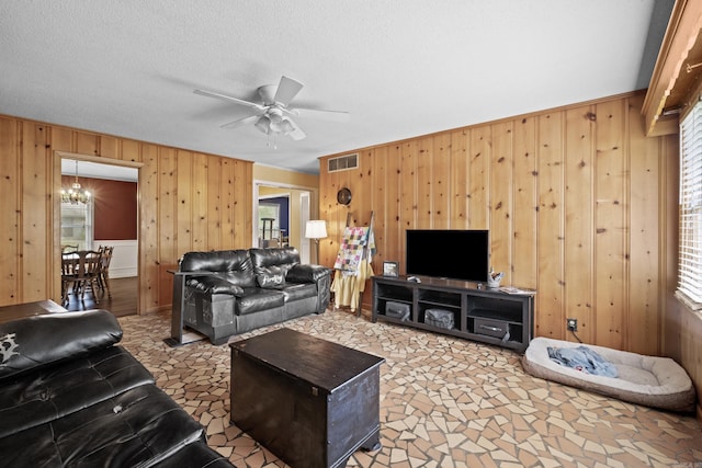 1903 W Arch Ave, Searcy, AR 72143 - living area featuring wood walls, ceiling fan, and a chandelier