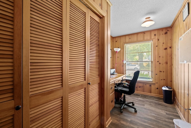 1903 W Arch Ave, Searcy, AR 72143 - home office with dark wood-style flooring, wood walls, and a textured ceiling