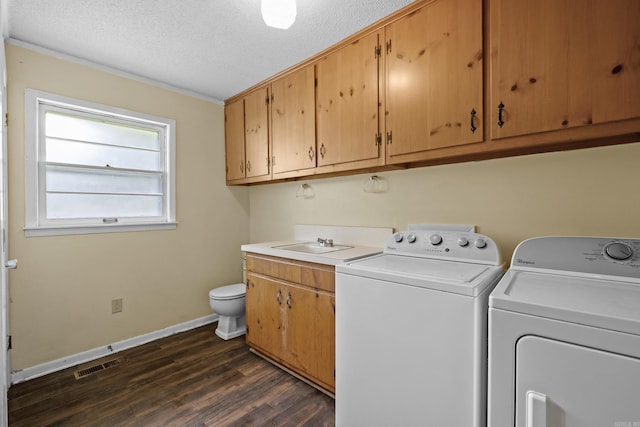 1903 W Arch Ave, Searcy, AR 72143 - laundry area with washing machine and dryer, a textured ceiling, dark wood finished floors, and crown molding