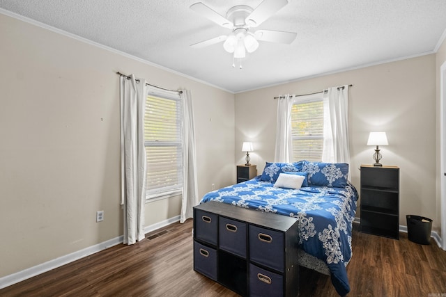 1903 W Arch Ave, Searcy, AR 72143 - bedroom featuring dark wood-style flooring, a textured ceiling, crown molding, and a ceiling fan