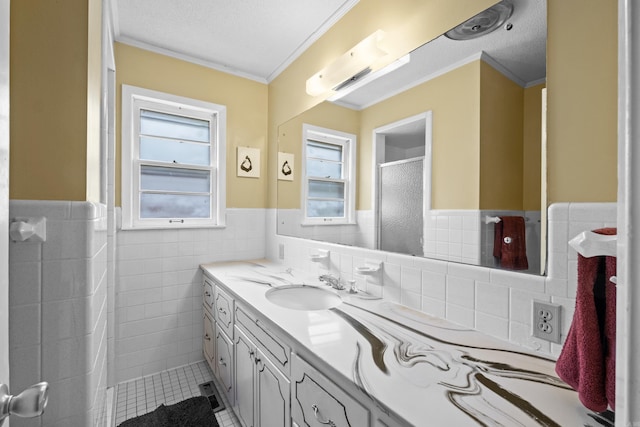 1903 W Arch Ave, Searcy, AR 72143 - bathroom with vanity, crown molding, wainscoting, tile patterned floors, and tile walls