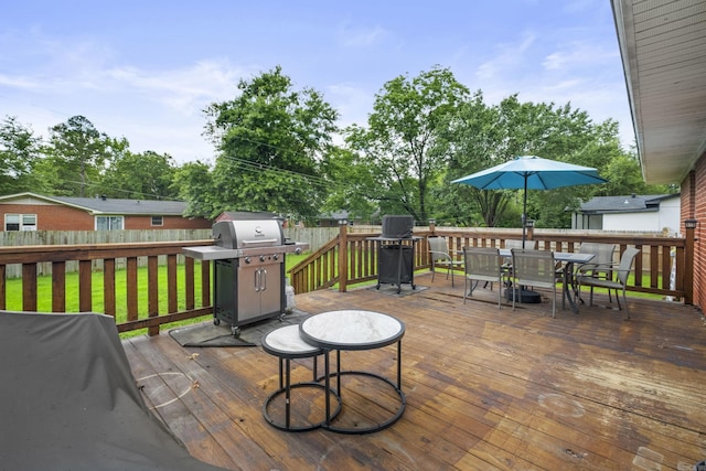 1903 W Arch Ave, Searcy, AR 72143 - wooden deck featuring a grill, outdoor dining space, and a fenced backyard