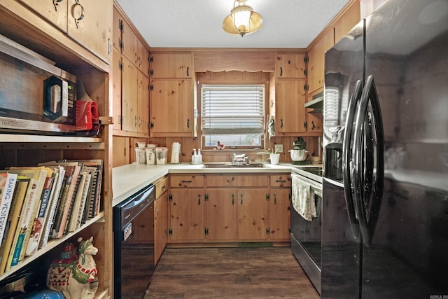 1903 W Arch Ave, Searcy, AR 72143 - kitchen with black appliances, under cabinet range hood, dark wood finished floors, and light countertops