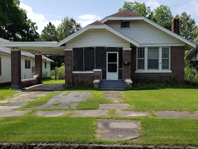 1508 W 18th Ave, Pine Bluff, AR 71603 - bungalow-style house featuring entry steps, a chimney, brick siding, and a front lawn