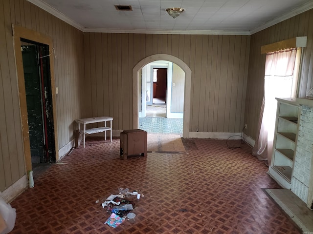 1504 W 18th Ave, Pine Bluff, AR 71603 - empty room with arched walkways, crown molding, and wood walls