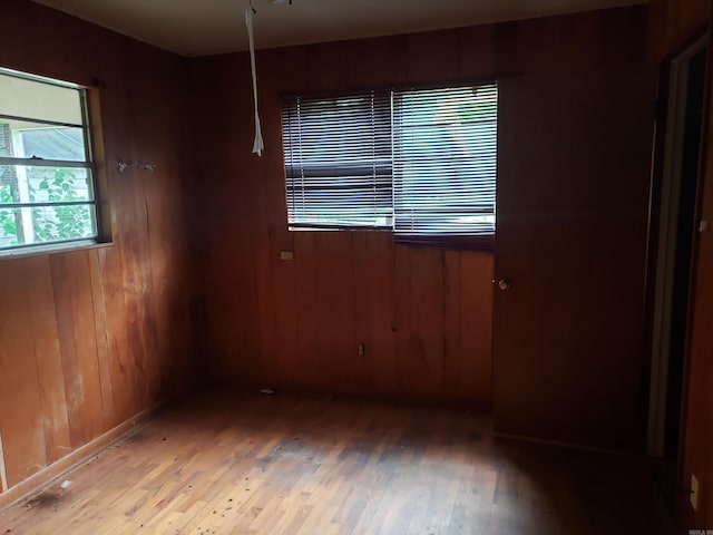 1504 W 18th Ave, Pine Bluff, AR 71603 - unfurnished room featuring light wood-type flooring and wood walls
