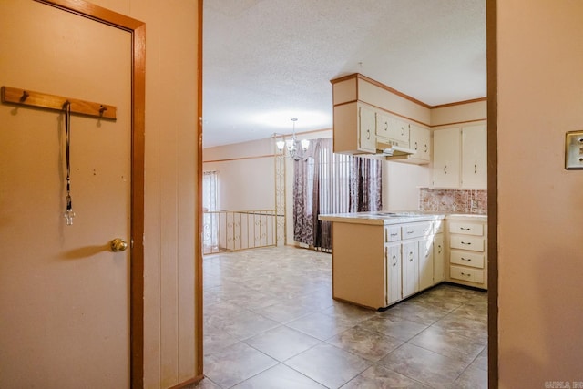 337 Lance Cir, Hot Springs, AR 71901 - kitchen featuring a chandelier, a peninsula, light countertops, cream cabinets, and light tile patterned floors