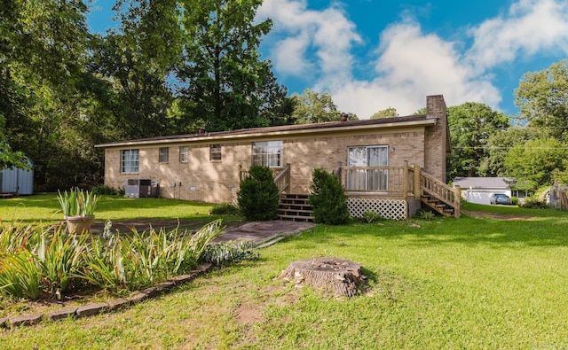 337 Lance Cir, Hot Springs, AR 71901 - view of front of house featuring a front yard, a chimney, a deck, and brick siding