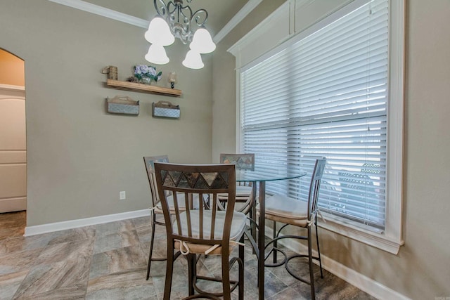 2148 Avondale Dr, Benton, AR 72019 - dining space featuring crown molding, a chandelier, plenty of natural light, arched walkways, and stone finish flooring