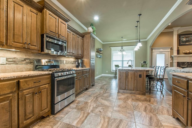 2148 Avondale Dr, Benton, AR 72019 - kitchen with appliances with stainless steel finishes, arched walkways, decorative backsplash, crown molding, and a kitchen bar