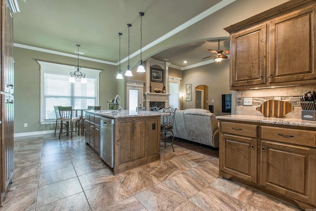 2148 Avondale Dr, Benton, AR 72019 - kitchen featuring ceiling fan, stainless steel dishwasher, arched walkways, crown molding, and a fireplace