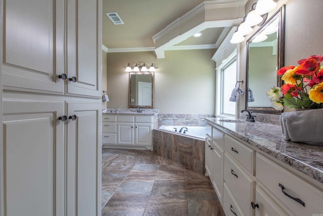 2148 Avondale Dr, Benton, AR 72019 - full bath with ornamental molding, a garden tub, two vanities, and stone finish floors
