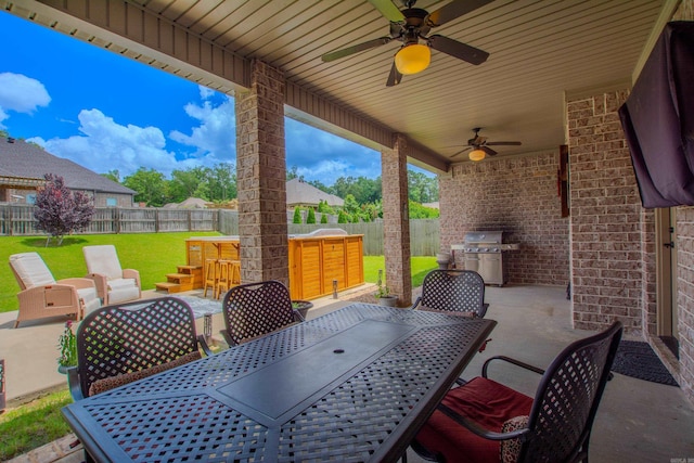 2148 Avondale Dr, Benton, AR 72019 - fenced backyard with outdoor dining space, ceiling fan, grilling area, and a patio area