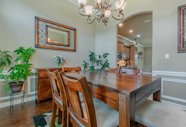 2148 Avondale Dr, Benton, AR 72019 - dining area with crown molding, a chandelier, arched walkways, dark wood-type flooring, and recessed lighting