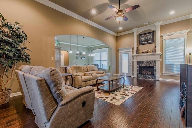 2148 Avondale Dr, Benton, AR 72019 - living area with arched walkways, ceiling fan, dark wood-style floors, a high end fireplace, and ornamental molding