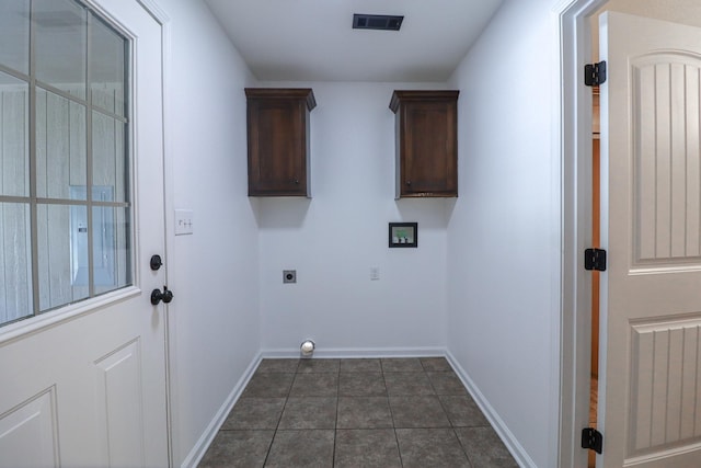1206 Ryan Ln, Paragould, AR 72450 - washroom with electric dryer hookup, dark tile patterned flooring, and cabinet space