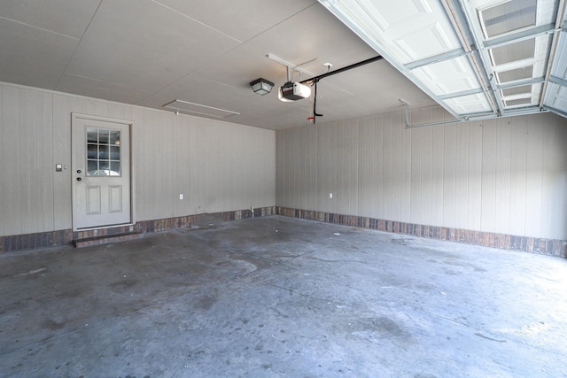 1206 Ryan Ln, Paragould, AR 72450 - garage with a garage door opener and wooden walls