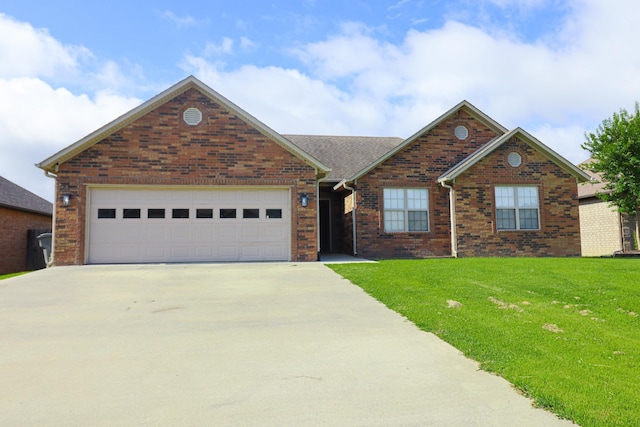 1206 Ryan Ln, Paragould, AR 72450 - view of front of home featuring concrete driveway, a front yard, brick siding, and an attached garage