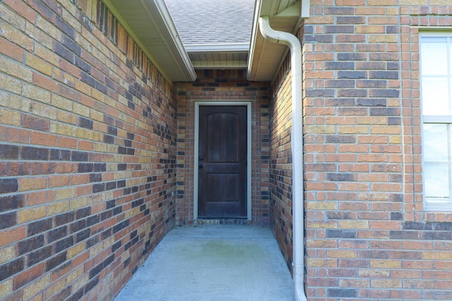 1206 Ryan Ln, Paragould, AR 72450 - view of exterior entry with roof with shingles and brick siding