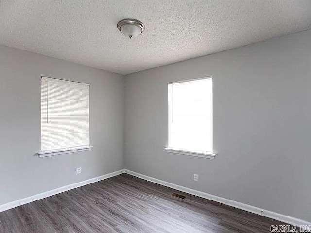 4207-4209 Moss St, North Little Rock, AR 72118 - empty room with wood finished floors and a textured ceiling