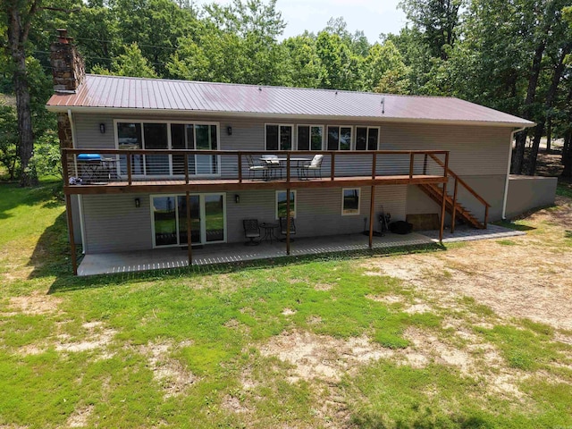 716 S Shore Dr, Horseshoe Bend, AR 72512 - rear view of property featuring a metal roof, a deck, a yard, a chimney, and a patio