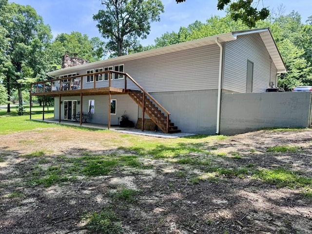 716 S Shore Dr, Horseshoe Bend, AR 72512 - rear view of house with stairway, a deck, and a chimney