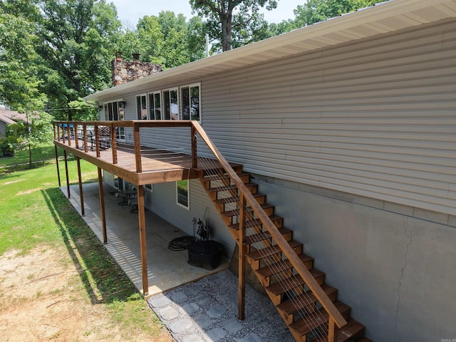 716 S Shore Dr, Horseshoe Bend, AR 72512 - back of house featuring stairs, a wooden deck, a patio, a chimney, and a yard