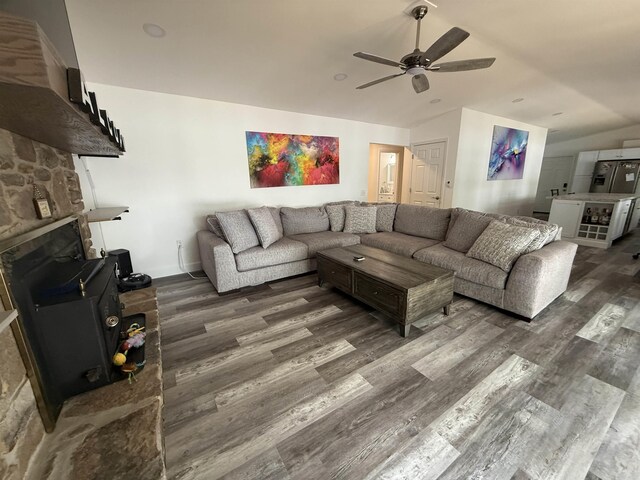 716 S Shore Dr, Horseshoe Bend, AR 72512 - living area with lofted ceiling, wood finished floors, ceiling fan, and a stone fireplace