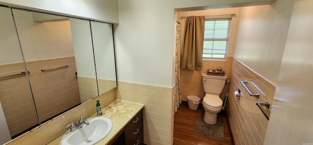 1000 Waverly Rd, Mountain Home, AR 72653 - bathroom with tile walls, a wainscoted wall, wood finished floors, and vanity