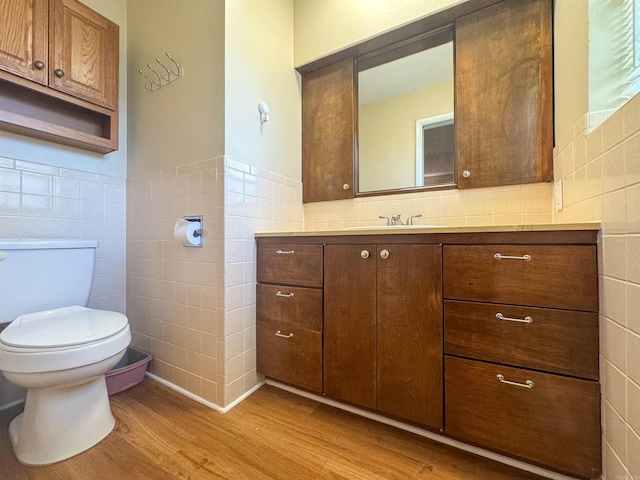 1000 Waverly Rd, Mountain Home, AR 72653 - bathroom featuring tile walls, wood finished floors, vanity, and wainscoting