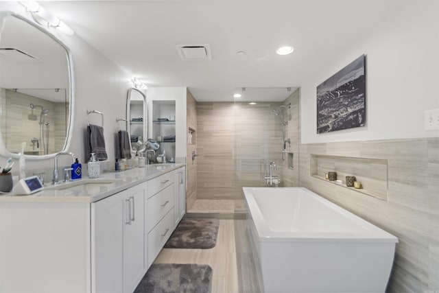 3700 Cantrell Rd Unit 1002, Little Rock, AR 72202 - bathroom with a freestanding tub, double vanity, a shower stall, and recessed lighting