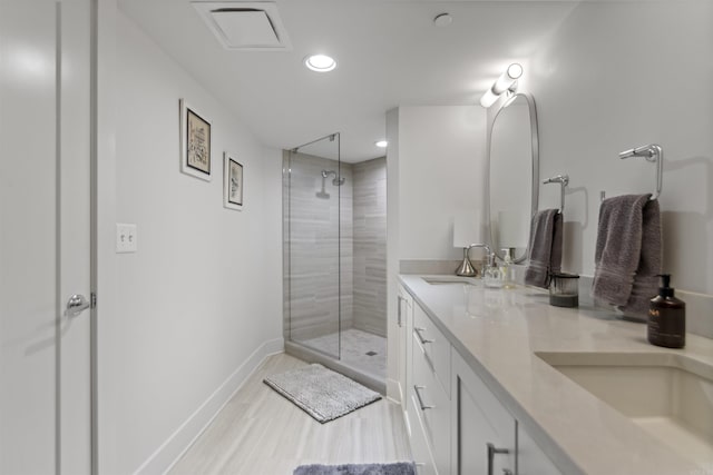 3700 Cantrell Rd Unit 1002, Little Rock, AR 72202 - bathroom with a tile shower, double vanity, wood finished floors, and recessed lighting