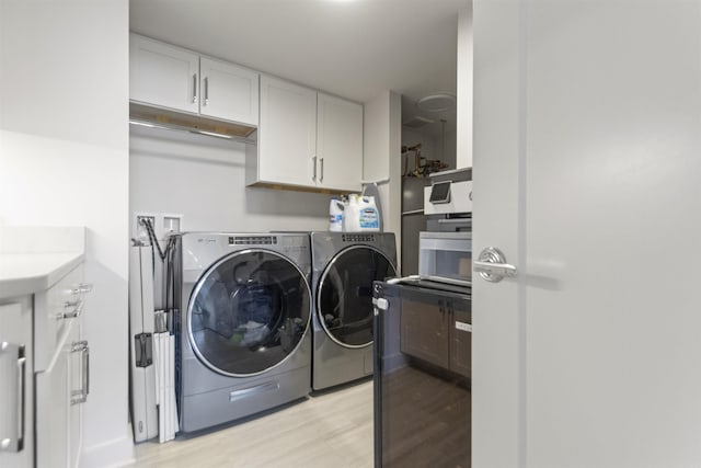 3700 Cantrell Rd Unit 1002, Little Rock, AR 72202 - laundry room with washing machine and dryer and light wood-style flooring