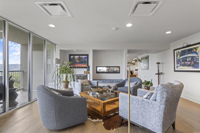3700 Cantrell Rd Unit 1002, Little Rock, AR 72202 - living area featuring wood finished floors, recessed lighting, and a multi sided fireplace