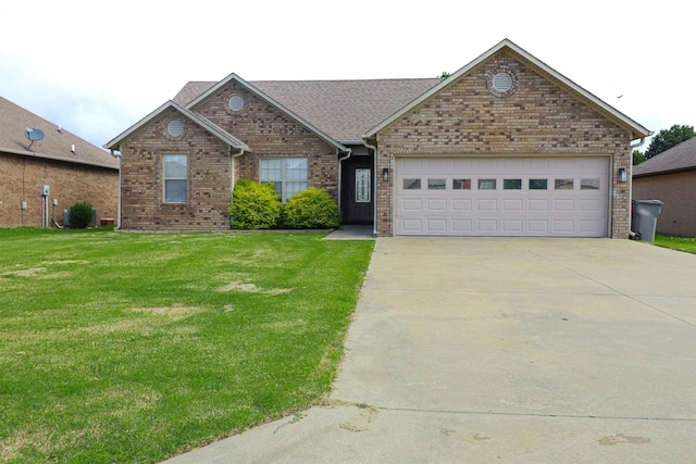 view of front of property with driveway, a front yard, brick siding, a garage, and a shingled roof