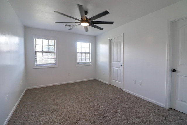 empty room featuring ceiling fan and carpet floors