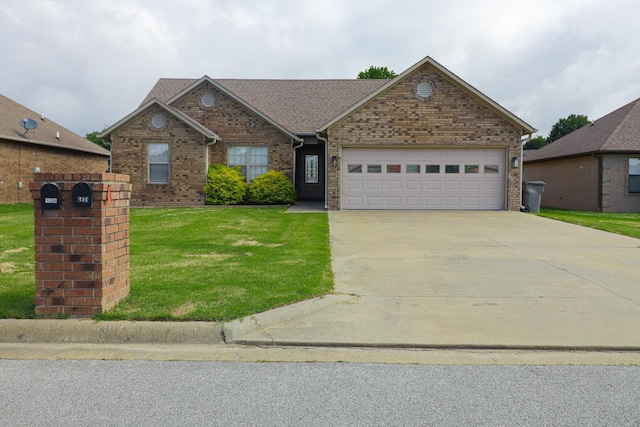view of front facade featuring a front lawn, driveway, an attached garage, and brick siding