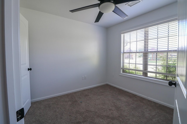 carpeted empty room with ceiling fan and baseboards