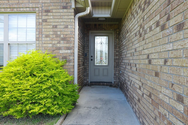 property entrance with brick siding