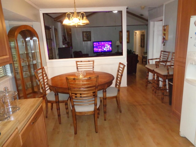 2 Wellington Ct, Little Rock, AR 72227 - dining room with light wood finished floors, a chandelier, and ornamental molding