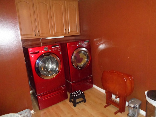 2 Wellington Ct, Little Rock, AR 72227 - laundry area with washing machine and dryer, cabinet space, and light wood-style flooring