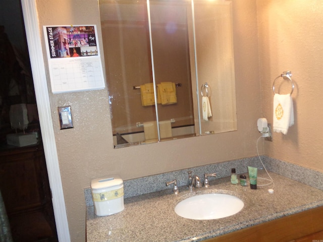 2 Wellington Ct, Little Rock, AR 72227 - bathroom with vanity and a textured wall