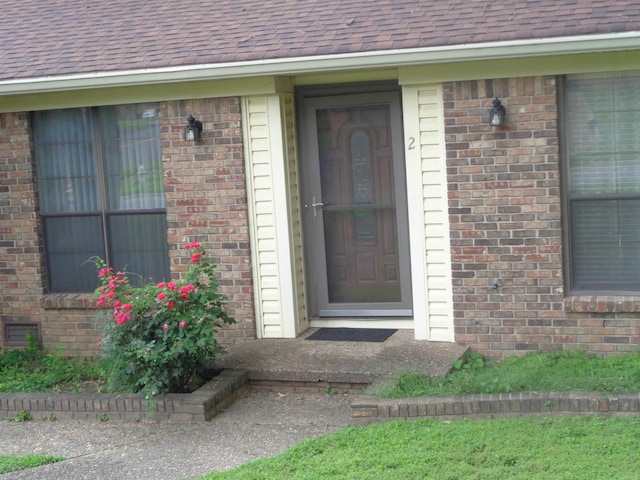2 Wellington Ct, Little Rock, AR 72227 - doorway to property with brick siding and roof with shingles