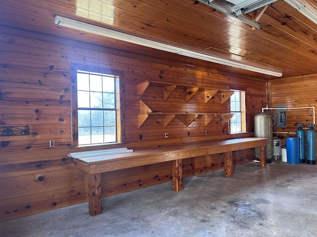 miscellaneous room with wooden walls, electric panel, concrete flooring, and wood ceiling