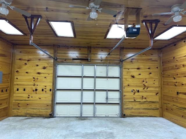 garage with ceiling fan, a garage door opener, wooden walls, and wooden ceiling