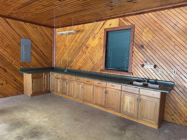 misc room featuring electric panel, wood walls, and concrete flooring