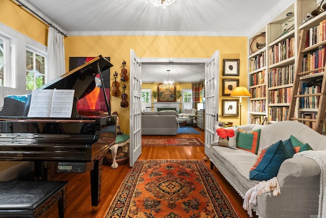 445 Midland St, Little Rock, AR 72205 - living area featuring wood finished floors, ornamental molding, a fireplace, a chandelier, and built in features