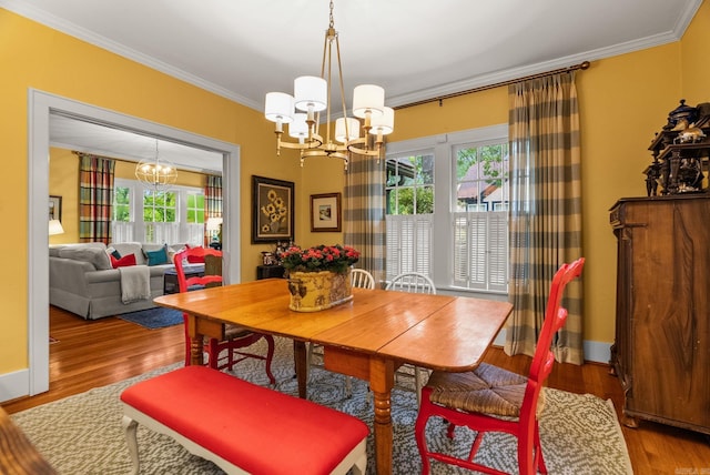 445 Midland St, Little Rock, AR 72205 - dining area featuring a chandelier, crown molding, and wood finished floors